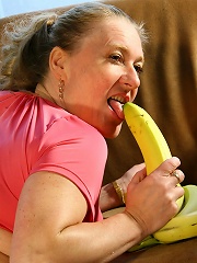 Naughty housewife playing with a banana